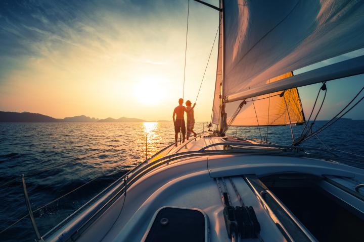 couple on sailboat at sunset